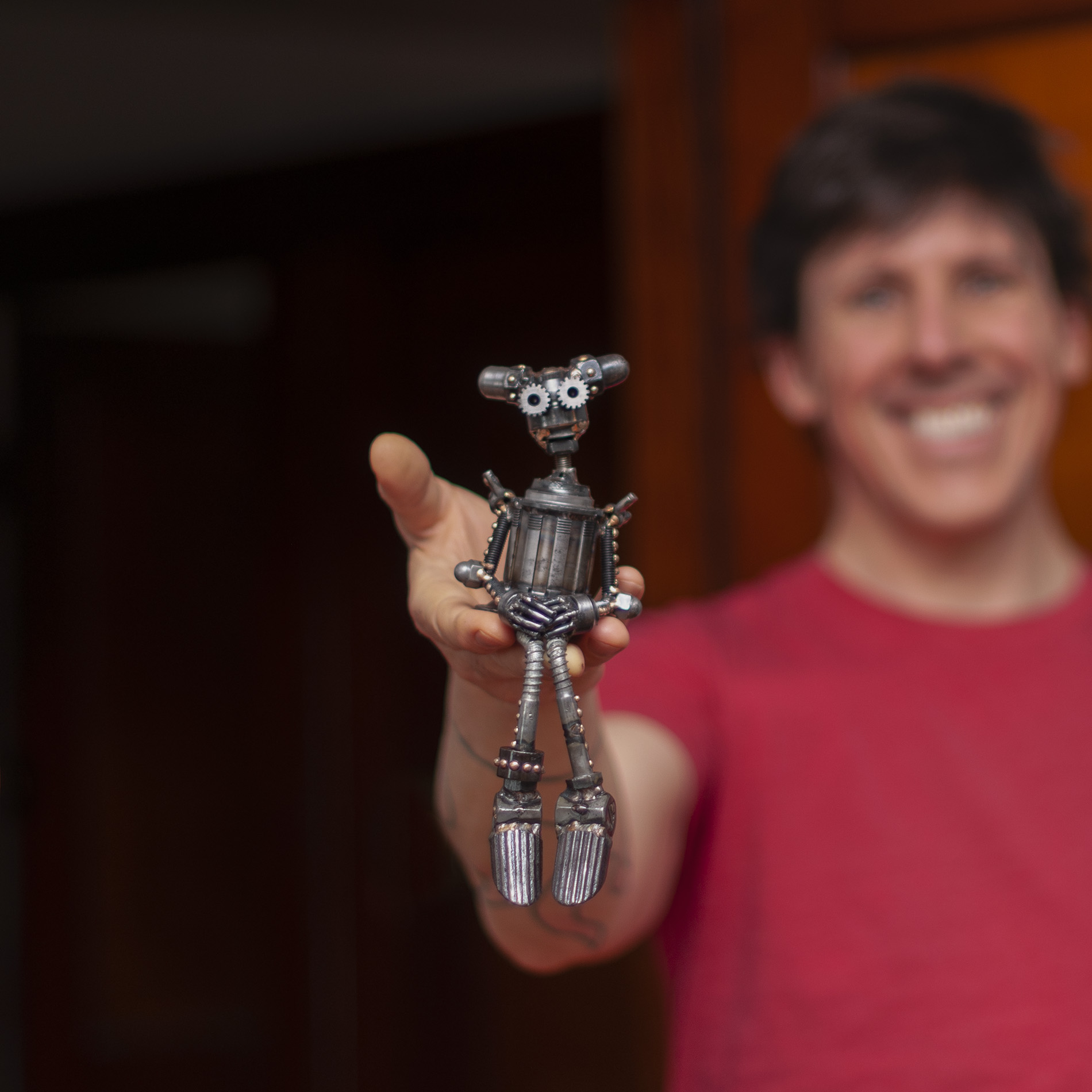 Artist with Sculpture of a small lady robot named Star